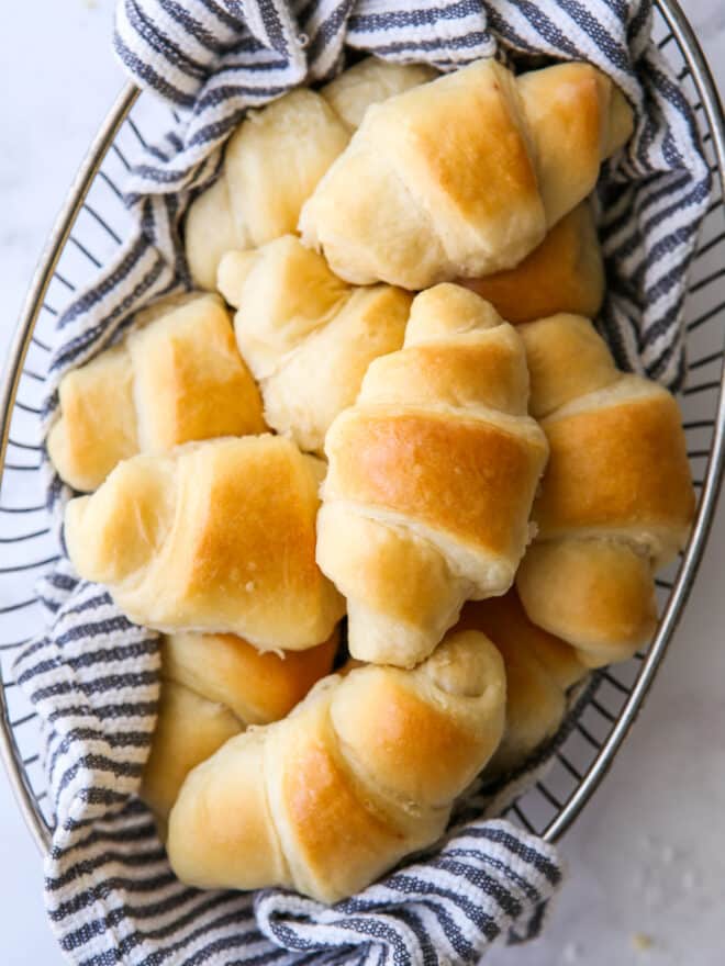 closeup of easy no-knead fairy crescent rolls in a bread basket