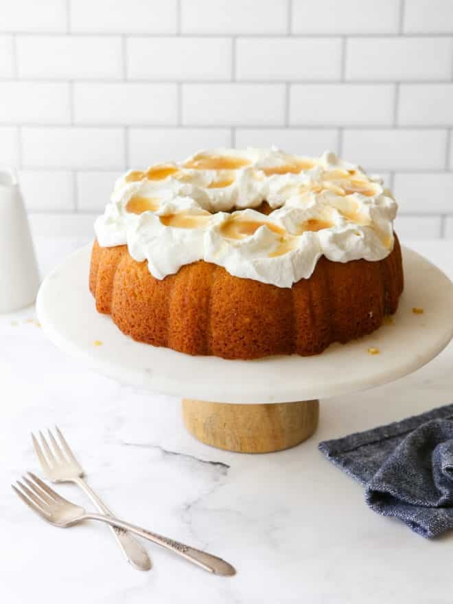 maple bundt cake on a cake stand with forks on the table