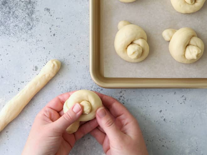 shaping white dinner roll knots
