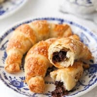 closeup of puff pastry chocolate croissants on a plate
