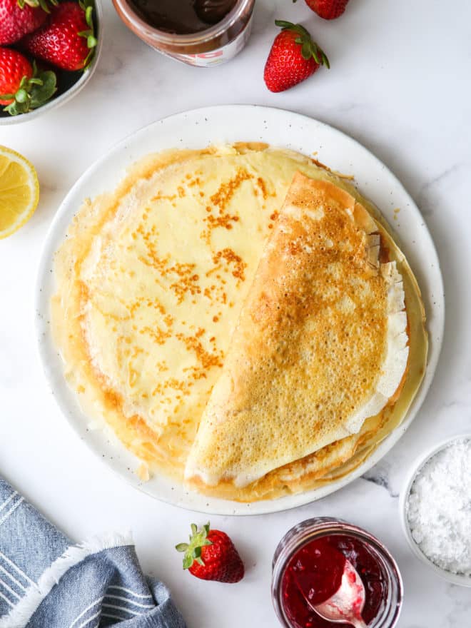 a stack of homemade crepes on a plate