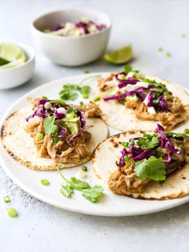 close up view of slow cooker korean pork tacos on a plate