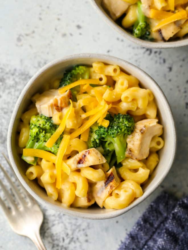 bowl with chicken broccoli macaroni and cheese and fork
