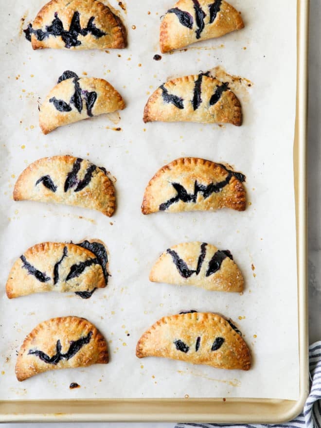 baked blueberry hand pies on a sheet pan
