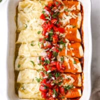 baked red and green chicken enchiladas with salsa on top