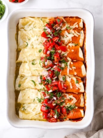 baked red and green chicken enchiladas with salsa on top
