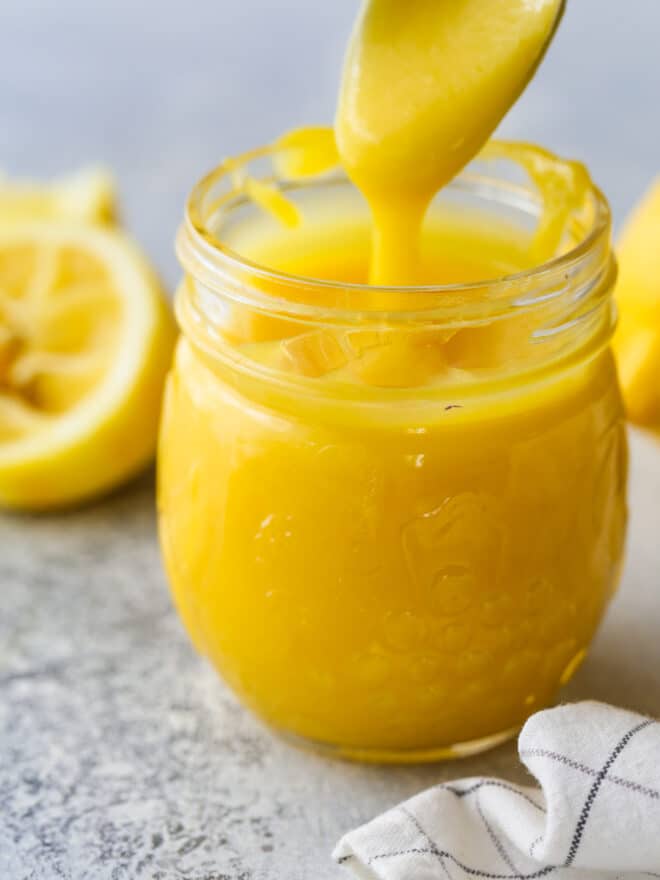 spooning lemon curd into jar