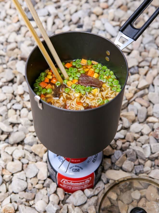 backpacking ramen soup in pot over camp stove