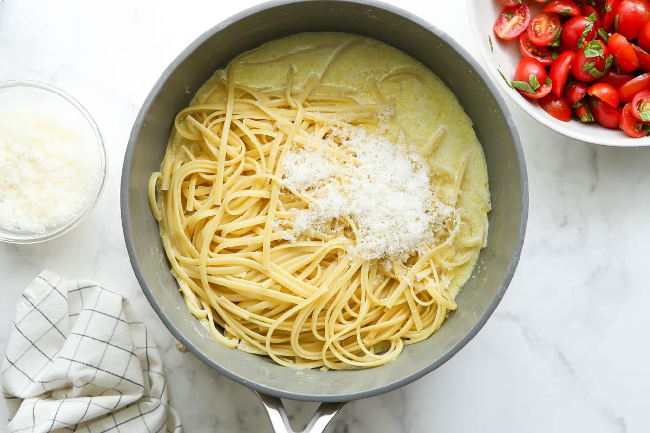 adding pasta to sauce in pot
