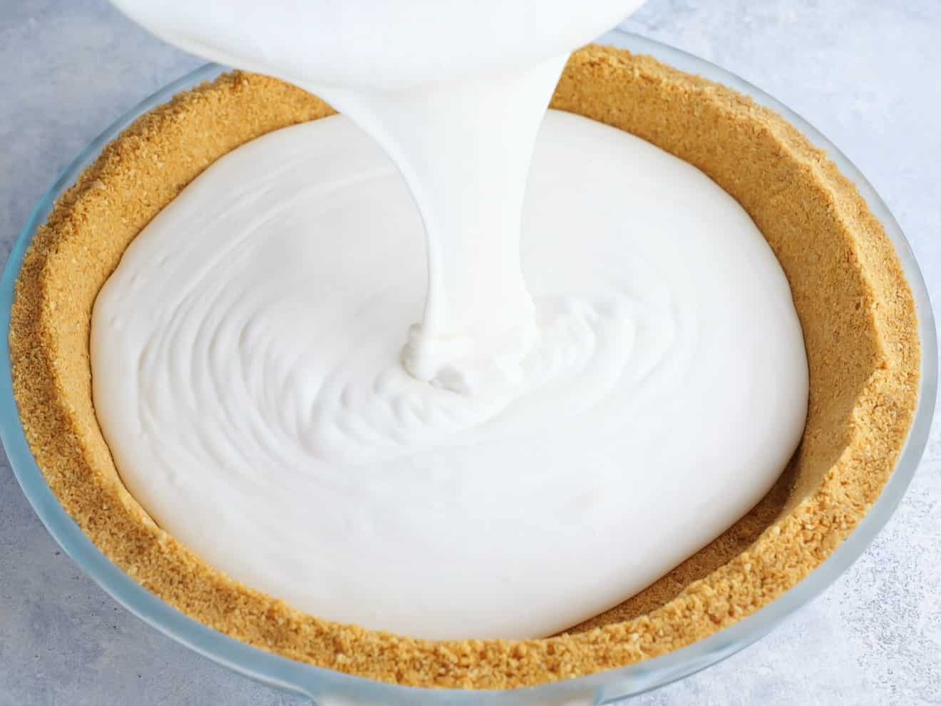 pouring ice cream filling into pie crust