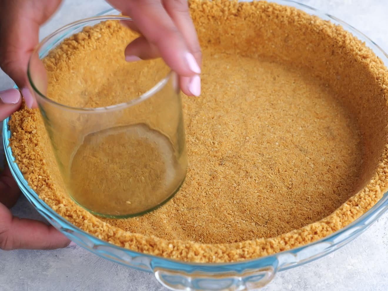 graham cracker crust going into pie pan
