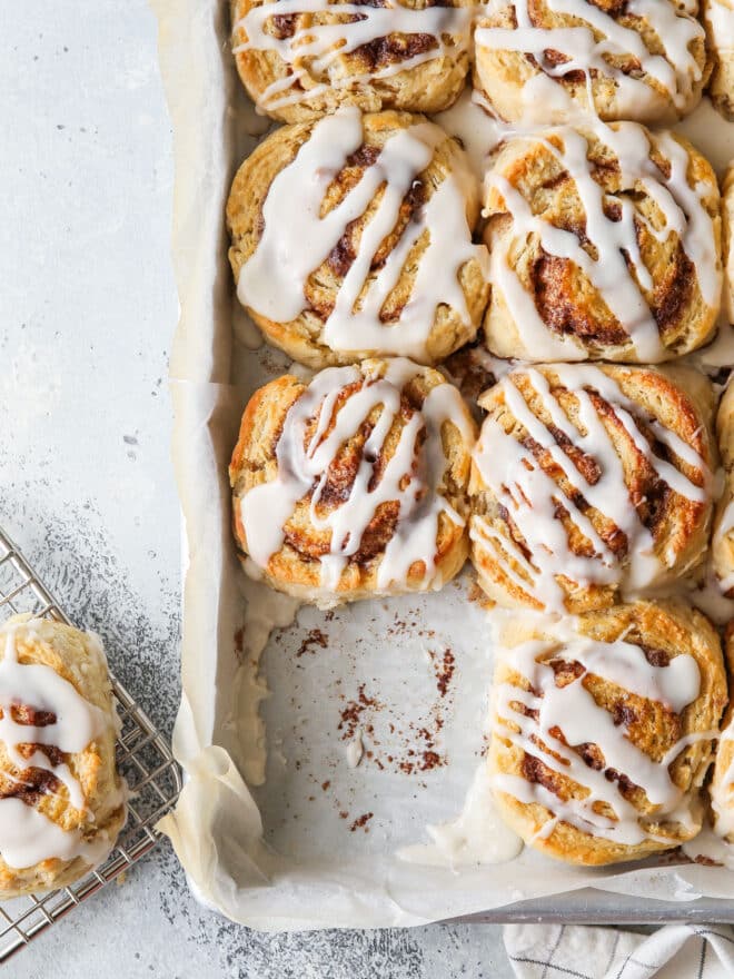 baked cinnamon roll biscuits in a pan with one missing
