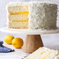 sliced lemon coconut cake on a cake stand