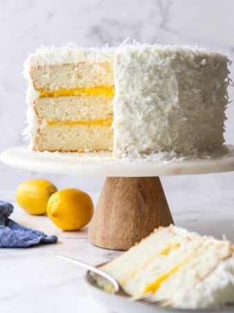 sliced lemon coconut cake on a cake stand