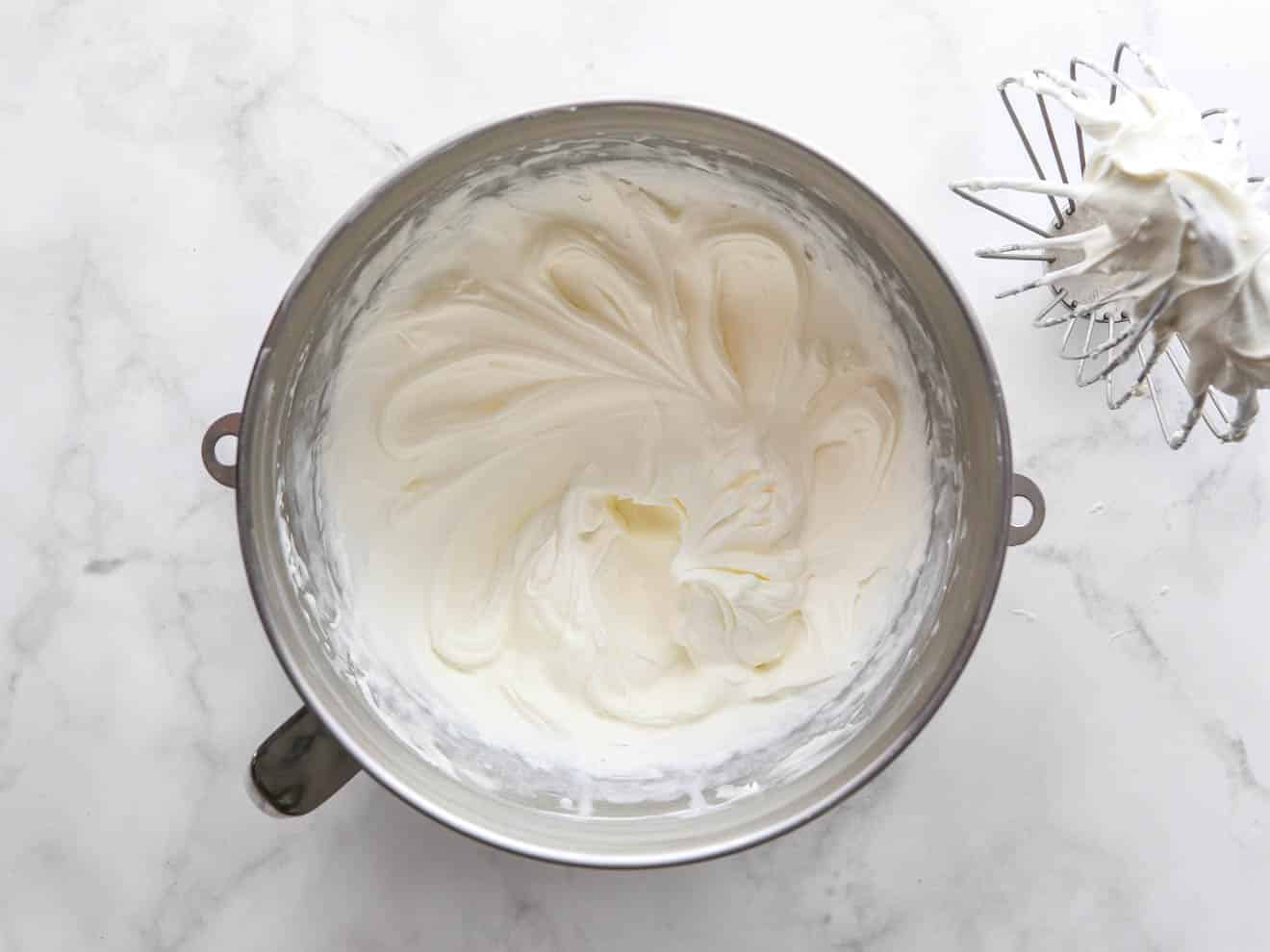 whipped chantilly frosting in mixing bowl