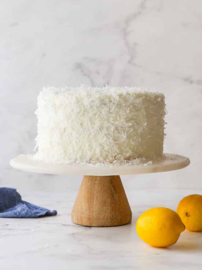 assembled lemon coconut cake on a plate stand