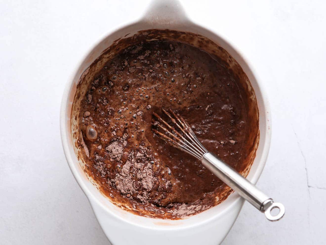 mixing chocolate cupcake batter in a bowl