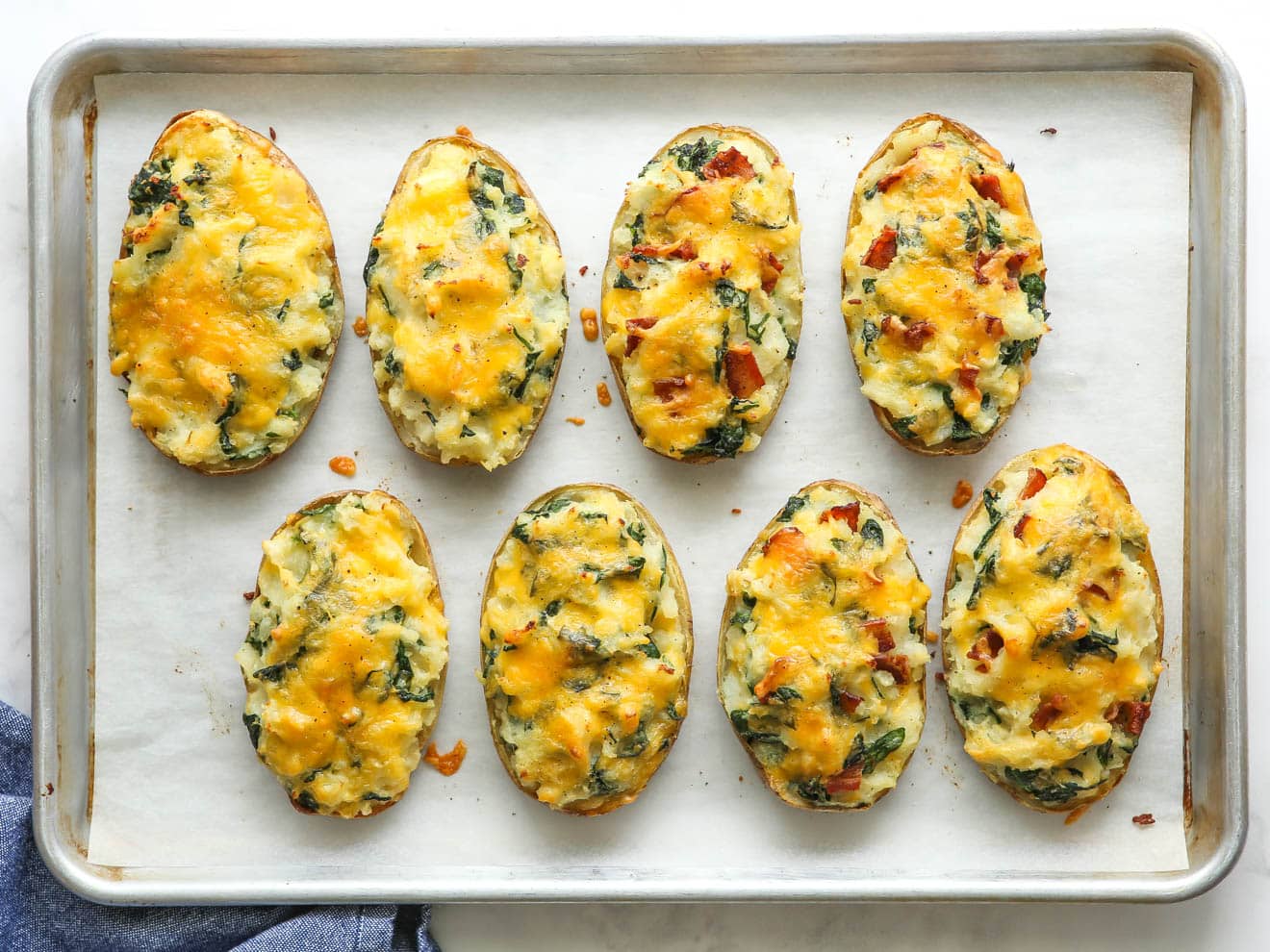 finished spinach and cheddar twice-baked potatoes on a sheet pan