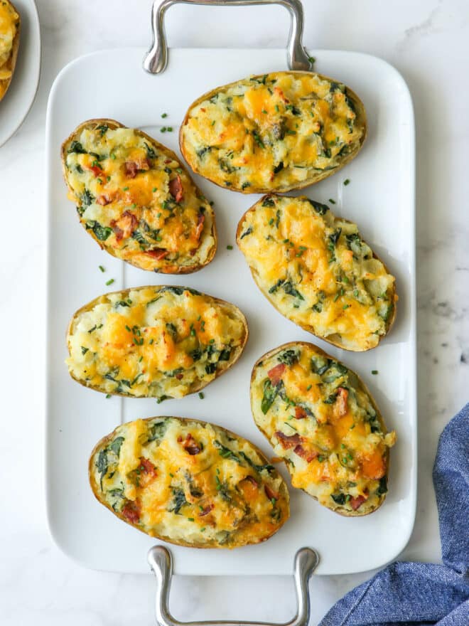 spinach and cheddar twice-baked potatoes on a large white platter