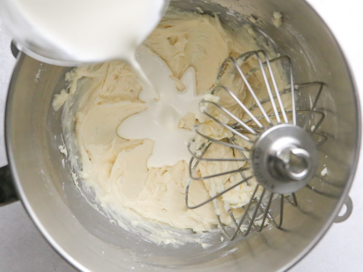 adding heavy cream to mixing bowl