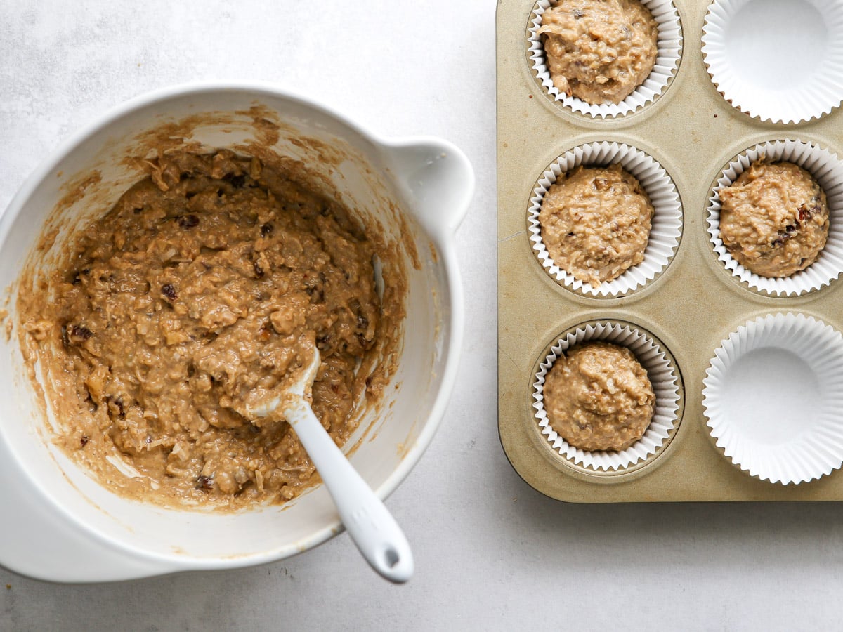 scooping bran muffin batter into muffin pan