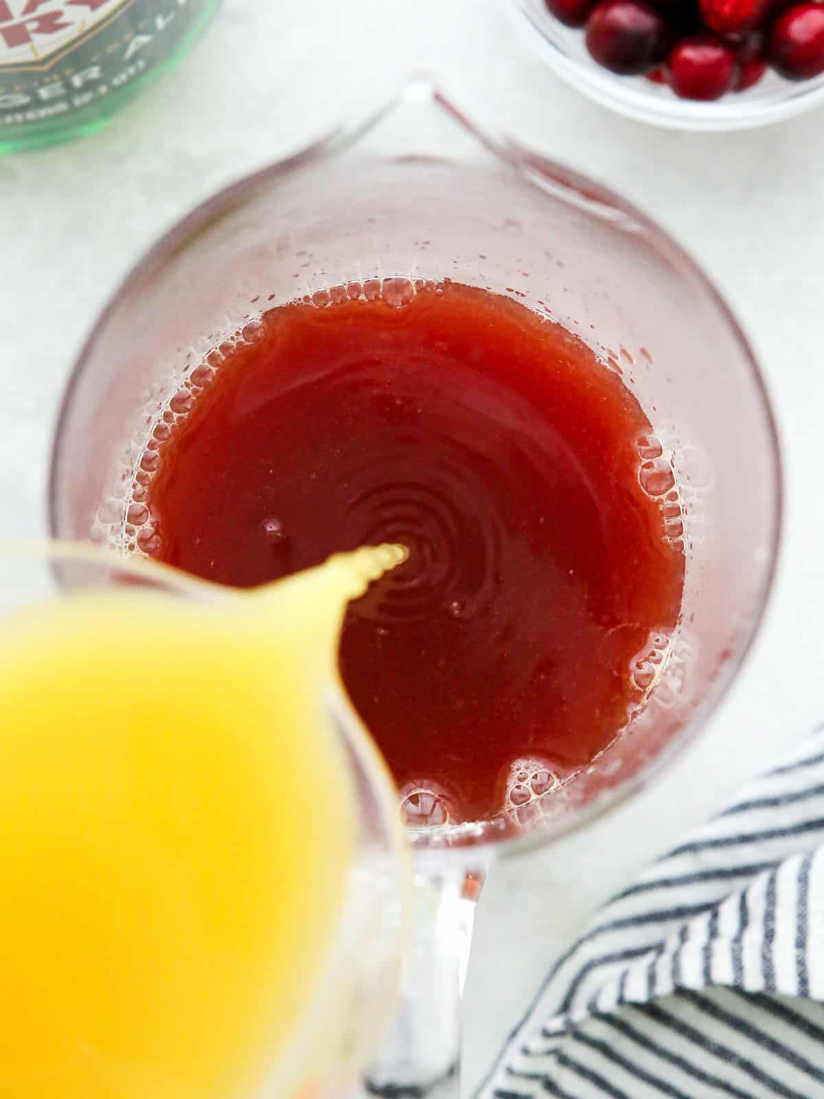 mixing holiday punch in a pitcher