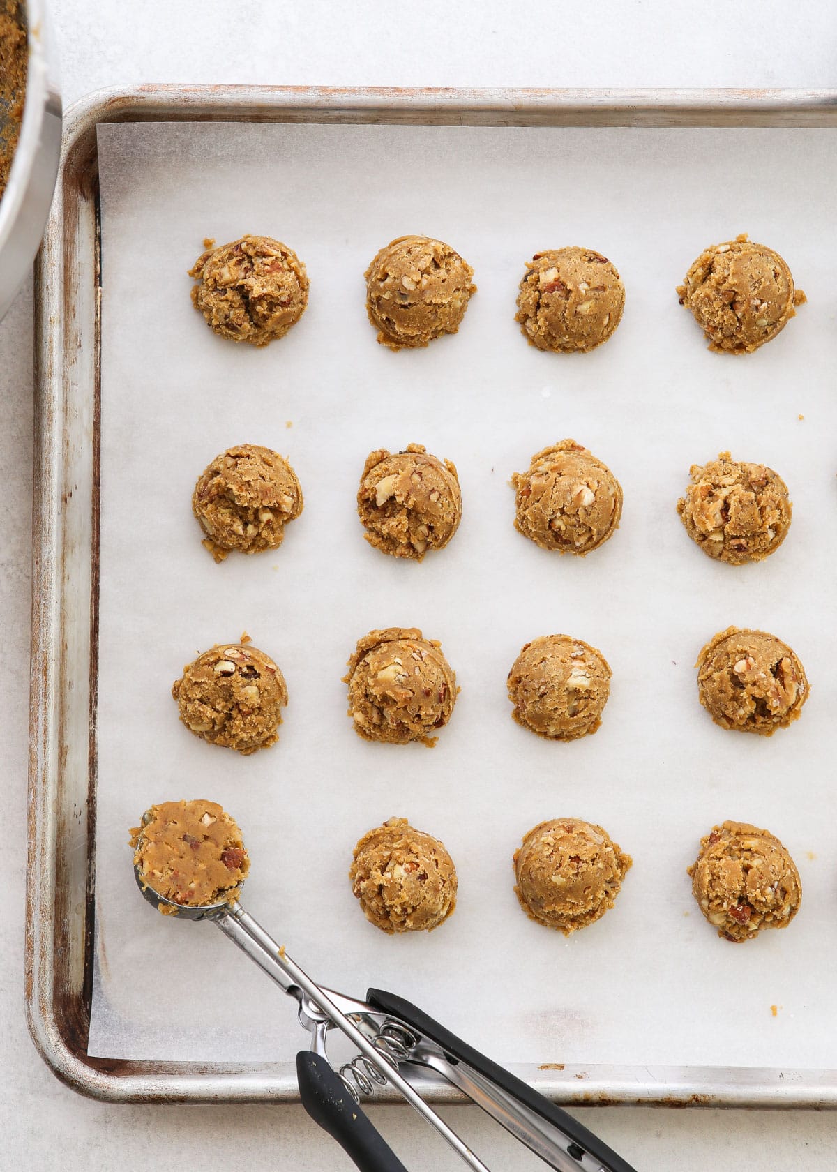 scooped cookie dough on sheet pan