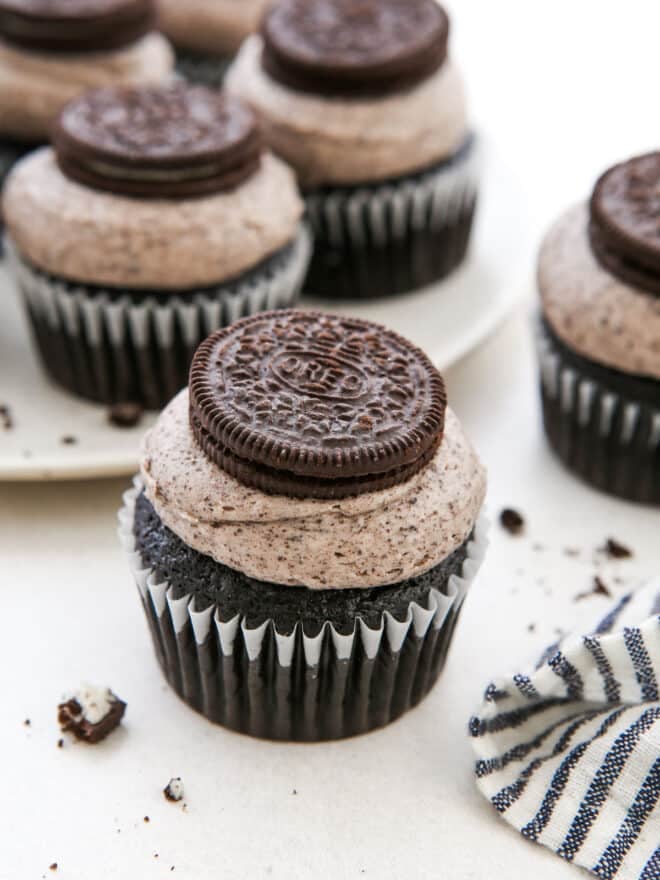 Beautiful Oreo cupcake with platter of cupcakes behind it