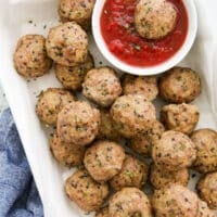 pork quinoa meatballs with a bowl of marinara sauce