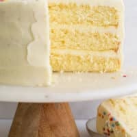 vanilla layer cake frosted on cake stand