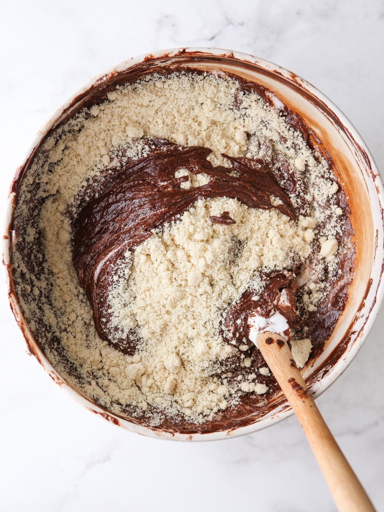 folding almond flour into chocolate cake batter