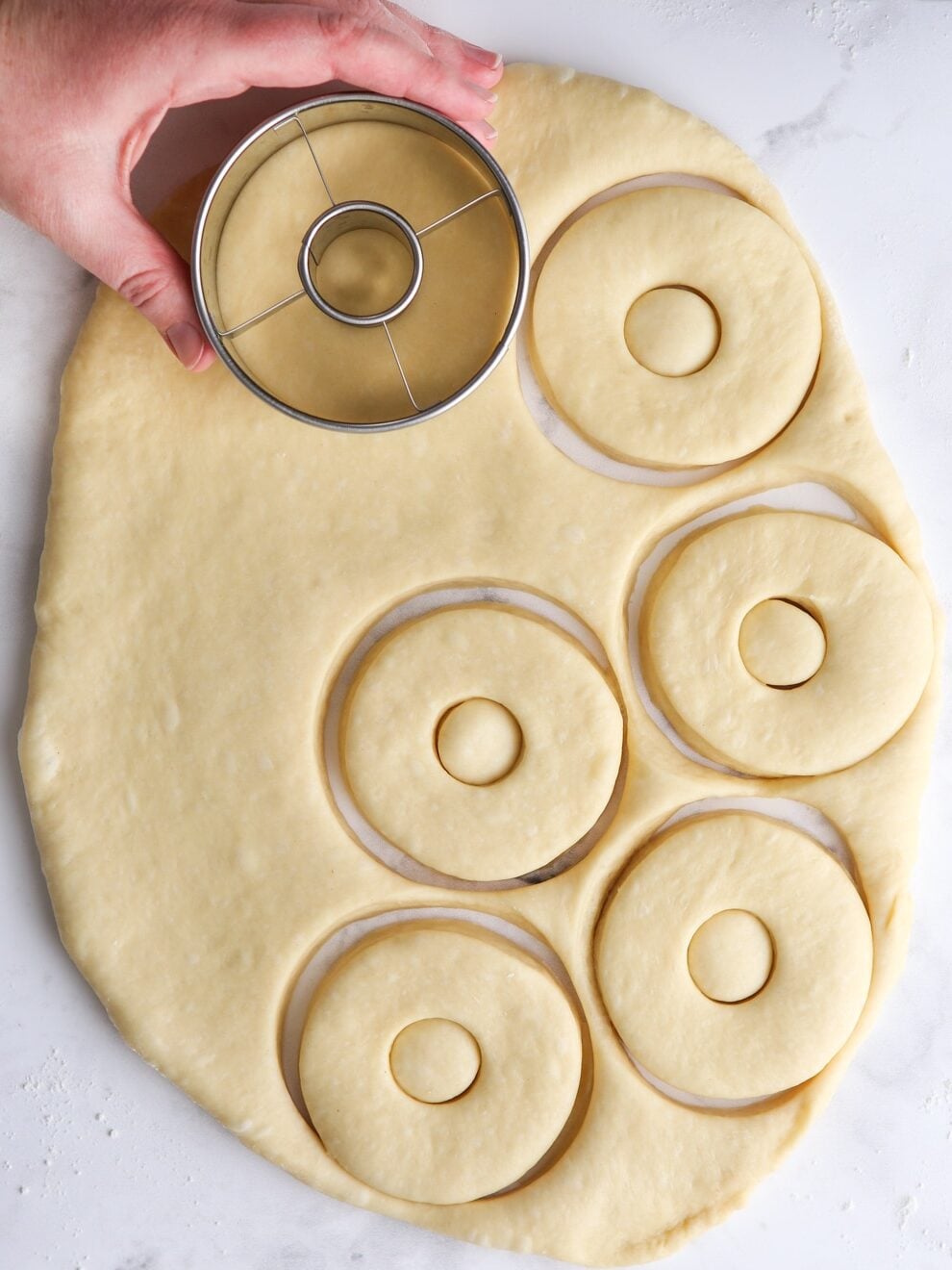 rolling out and cutting doughnuts