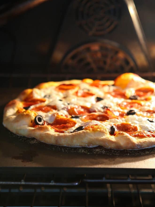 Cooking pizza in the pizza oven