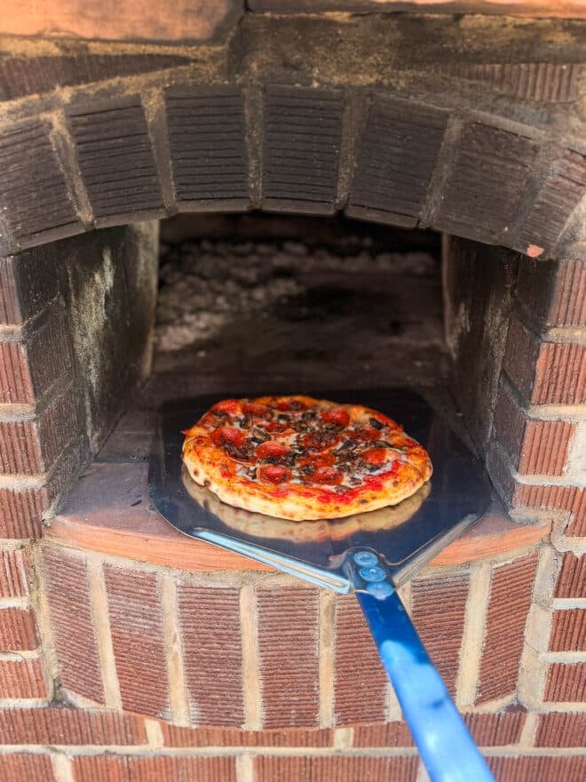 Sliding pizza out of the pizza oven